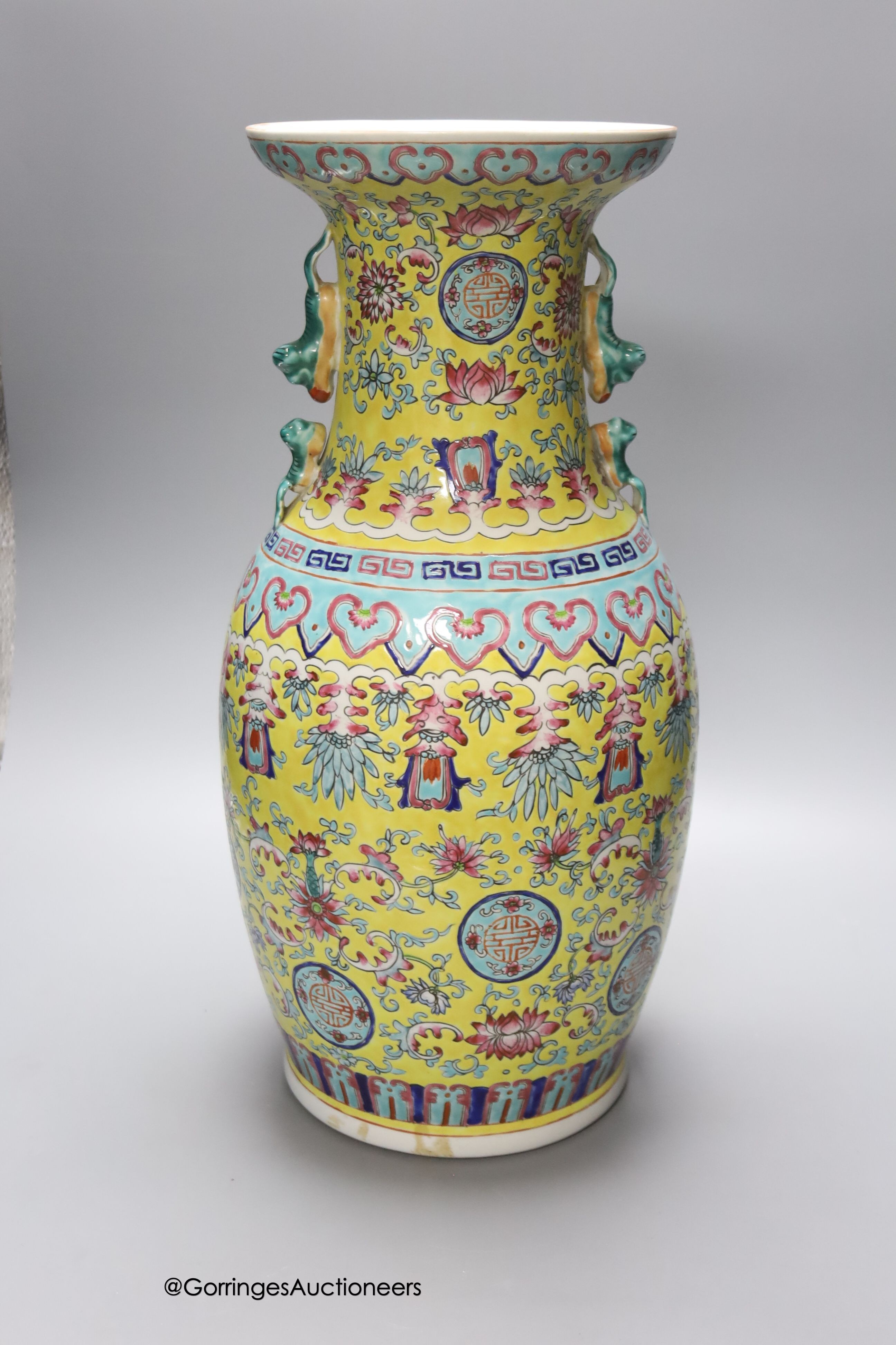 A Chinese yellow ground vase and another painted with chrysanthemums, tallest 46cm